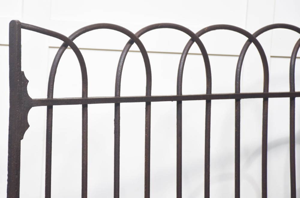 A pair of 19th-century wrought and cast iron gates featuring arched hoop tops, vertical pales, and central spearhead finials. View XI