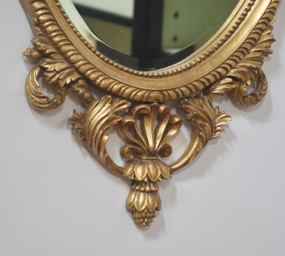  Pair of Adam style carved giltwood oval wall mirrors View V