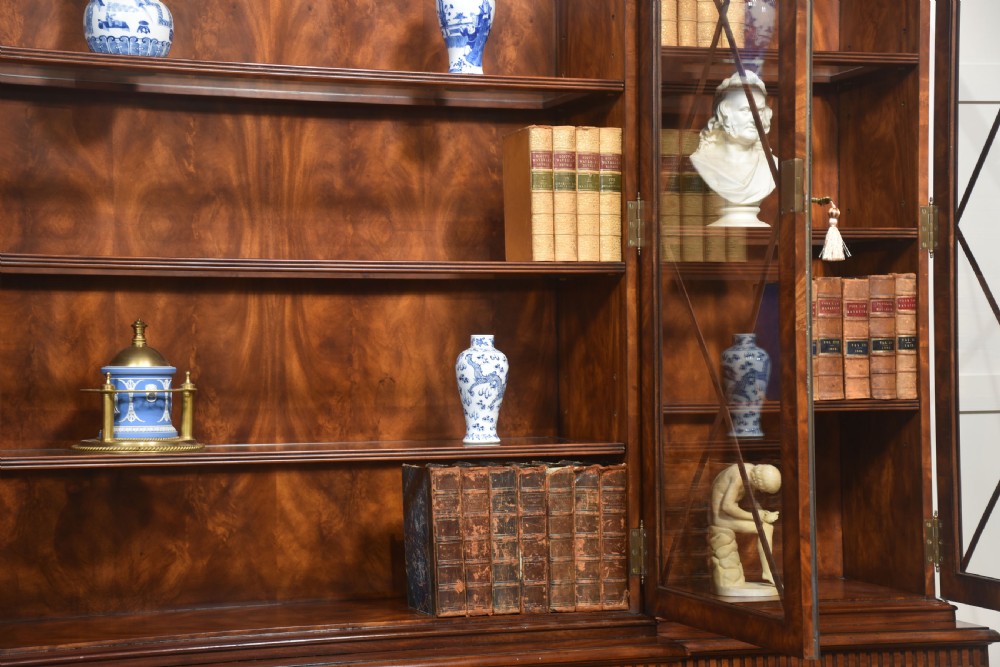 A large George III style mahogany breakfront library bookcase featuring glazed upper doors with astragal bars and a lower base with drawers and panelled cupboards. View IX
