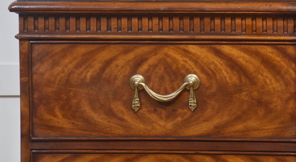 A large George III style mahogany breakfront library bookcase featuring glazed upper doors with astragal bars and a lower base with drawers and panelled cupboards. View XIII