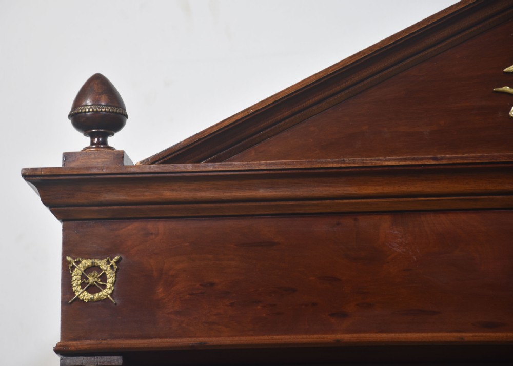 An Empire style mahogany wardrobe featuring twin mirrored doors, a classical pediment cornice, brass lion-ring drawer pulls, and gilt bronze mounts. View VI