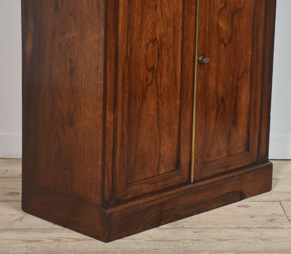 A tall 19th-century rosewood open bookcase with three upper shelves above a lower cabinet featuring two arched panel doors. View X
