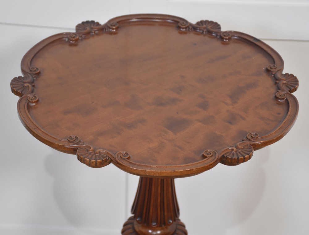 A George III satinwood tripod table with a piecrust rim resting on a fluted column and three carved cabriole legs. View VIII