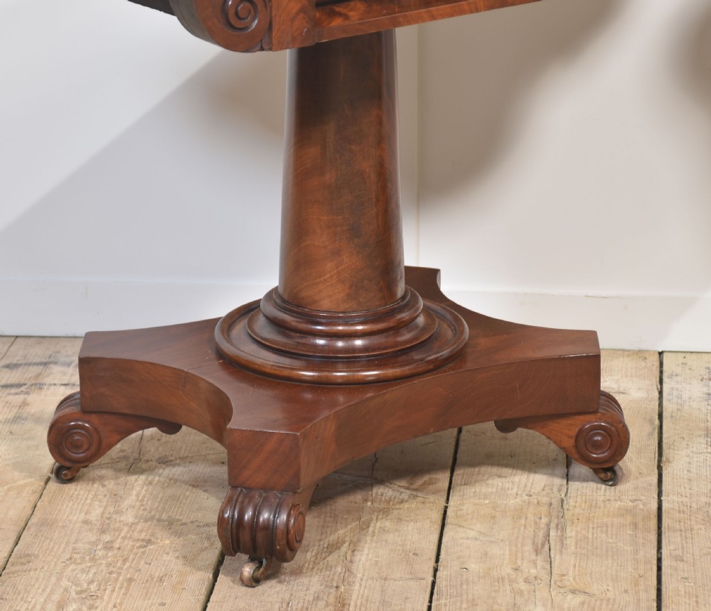 A pair of Regency mahogany fold-top tea tables resting on central cylindrical pedestals with quadruped scroll-foot bases. View VI