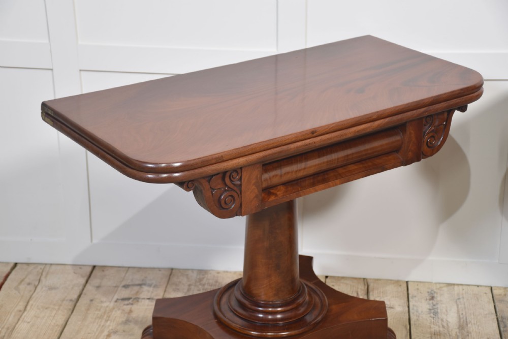 A pair of Regency mahogany fold-top tea tables resting on central cylindrical pedestals with quadruped scroll-foot bases. View VII