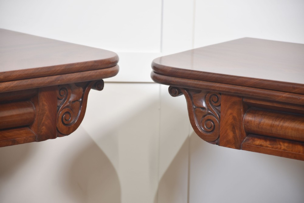 A pair of Regency mahogany fold-top tea tables resting on central cylindrical pedestals with quadruped scroll-foot bases. View VIII