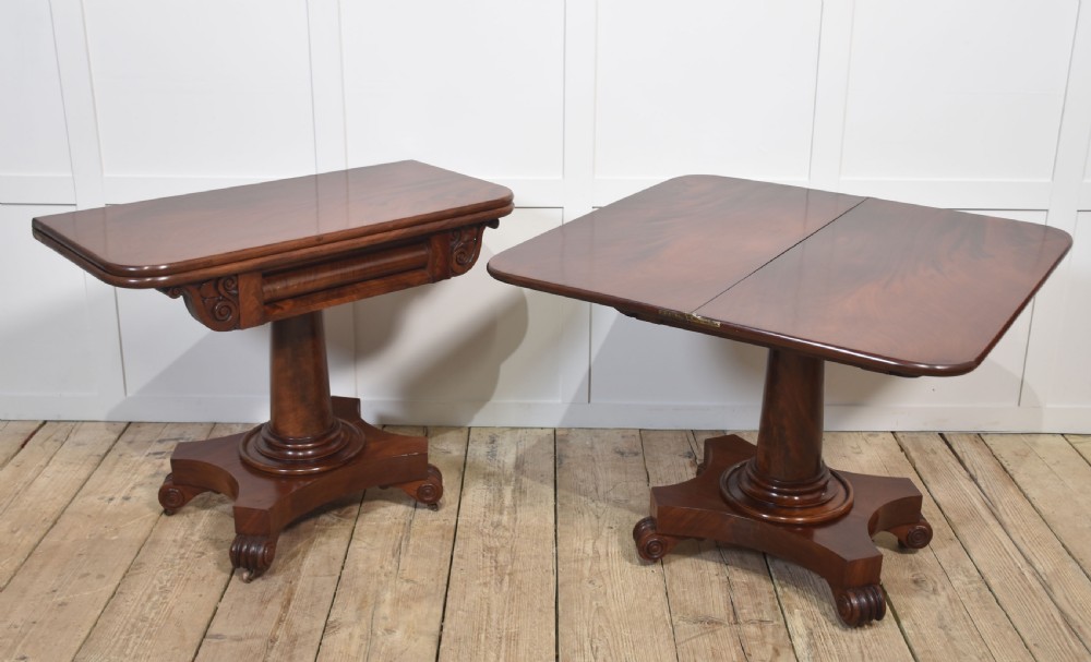 A pair of Regency mahogany fold-top tea tables resting on central cylindrical pedestals with quadruped scroll-foot bases. View XIII