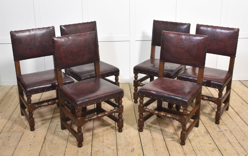 Eight leather upholstered oak dining chairs