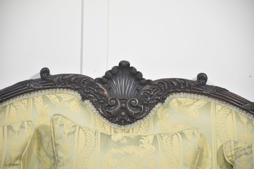 A pair of carved dark mahogany Chippendale revival settees upholstered in light sage patterned fabric with ball-and-claw feet. View XI