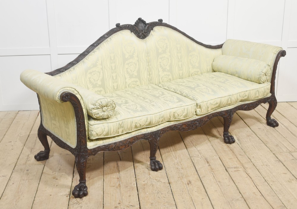 A pair of carved dark mahogany Chippendale revival settees upholstered in light sage patterned fabric with ball-and-claw feet. View XIII