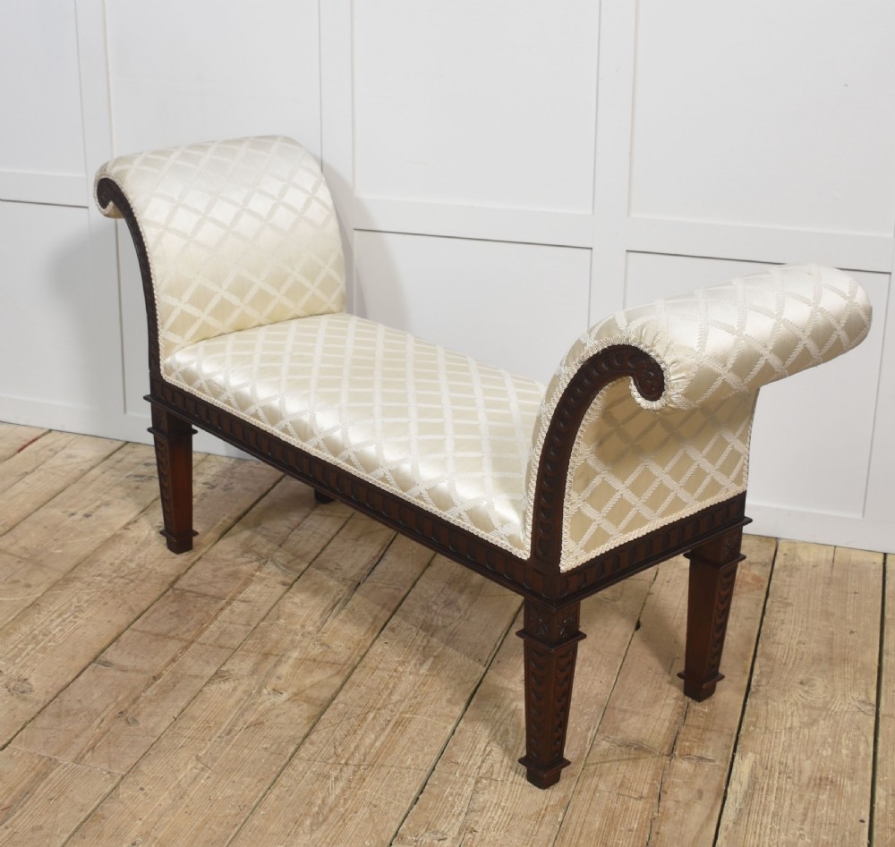 A carved mahogany window seat with out-curved scrolled arms, cream diamond-patterned fabric upholstery, and square tapered legs. View X