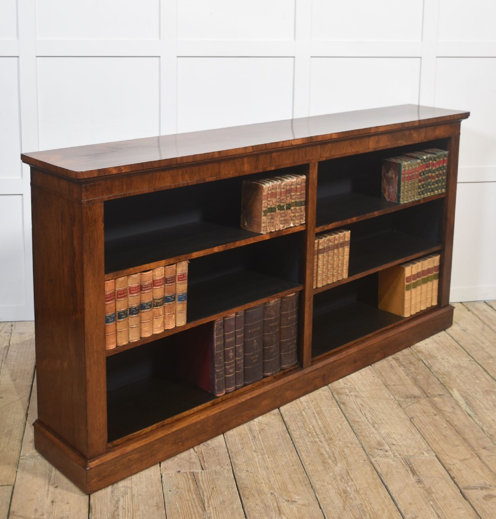 A nineteenth-century low rosewood open bookcase featuring two wide bays with adjustable horizontal shelves and a simple plinth base. View III