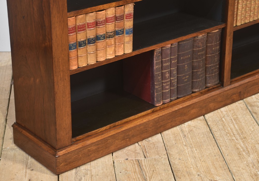 A nineteenth-century low rosewood open bookcase featuring two wide bays with adjustable horizontal shelves and a simple plinth base. View VI
