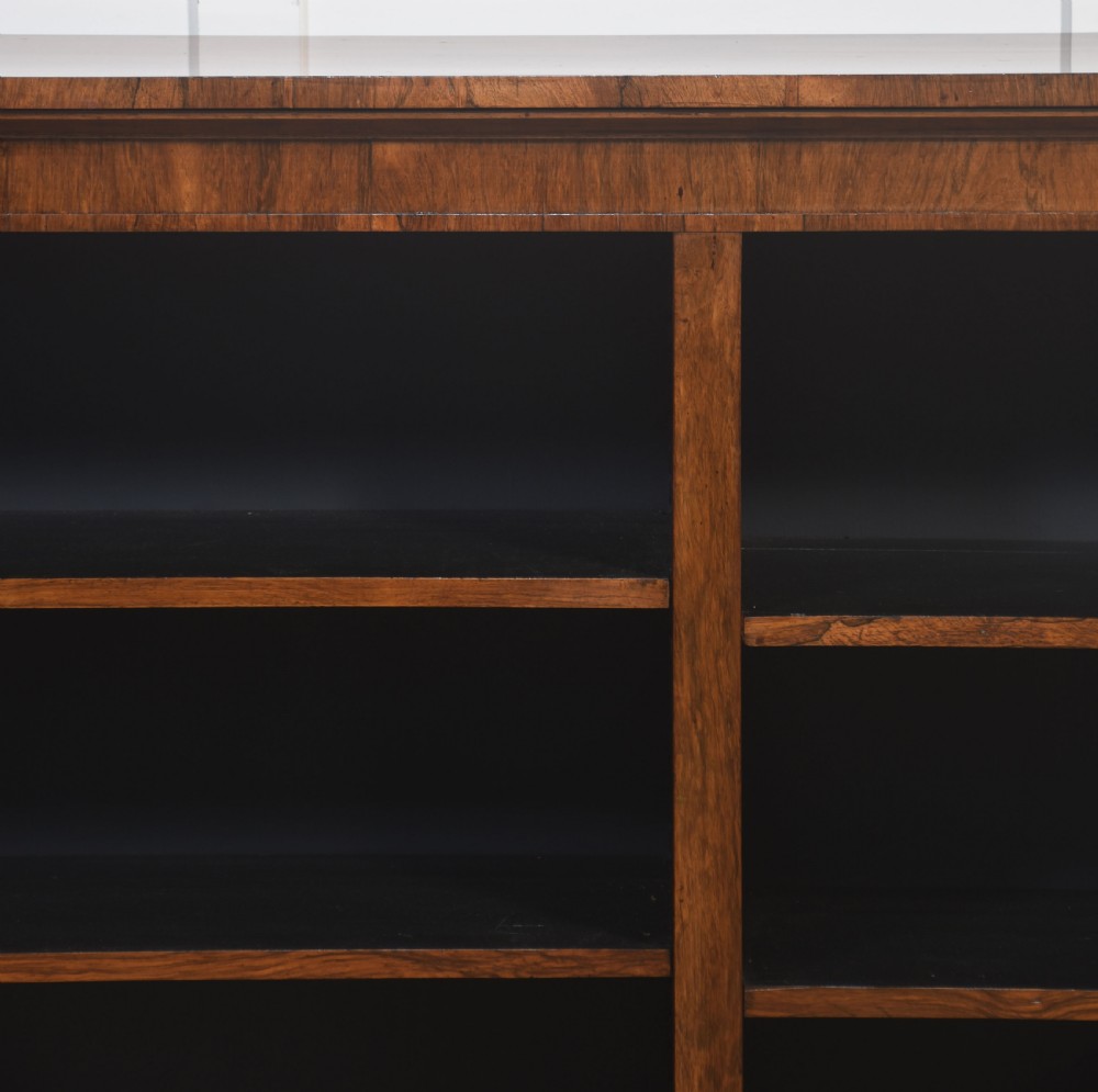 A nineteenth-century low rosewood open bookcase featuring two wide bays with adjustable horizontal shelves and a simple plinth base. View IX
