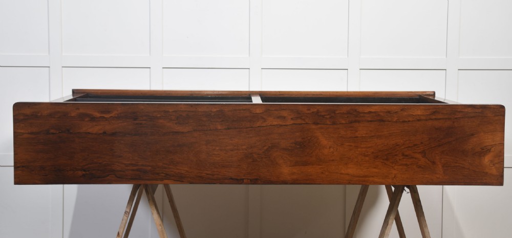 A nineteenth-century low rosewood open bookcase featuring two wide bays with adjustable horizontal shelves and a simple plinth base. View XIV