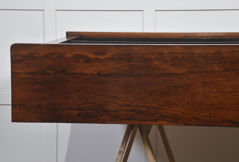 A nineteenth-century low rosewood open bookcase featuring two wide bays with adjustable horizontal shelves and a simple plinth base. View XV