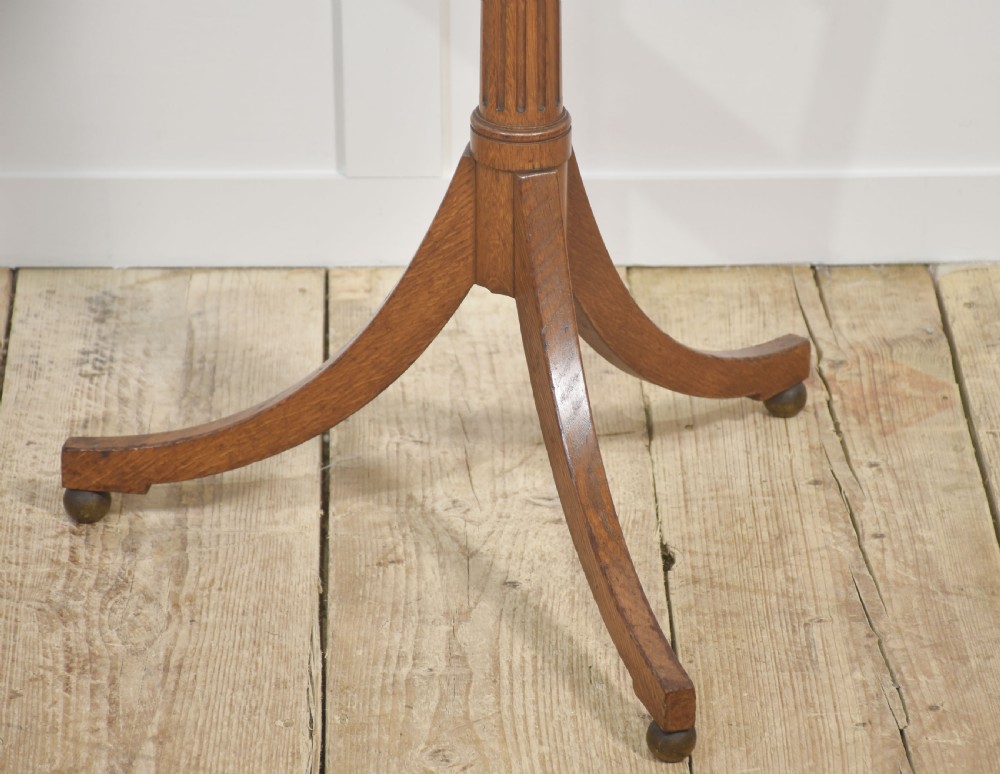 A pair of adjustable oak music stands featuring slatted wooden rests, fluted central columns, brass adjustment collars, and tripod bases. View V