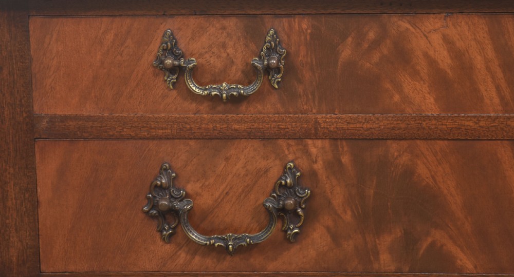 A polished mahogany cutlery chest table featuring two drawers with brass handles, raised on carved cabriole legs with ball and claw feet. View II