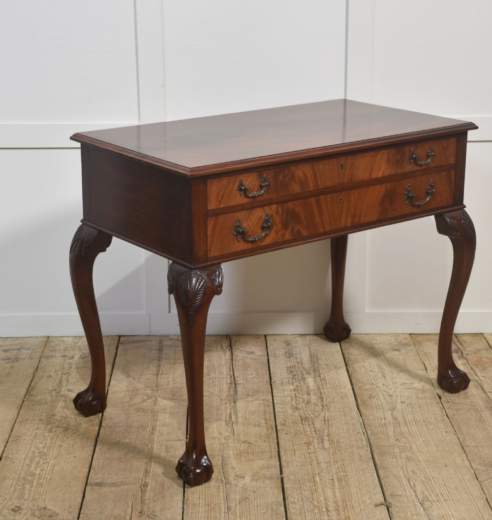 A polished mahogany cutlery chest table featuring two drawers with brass handles, raised on carved cabriole legs with ball and claw feet. View III