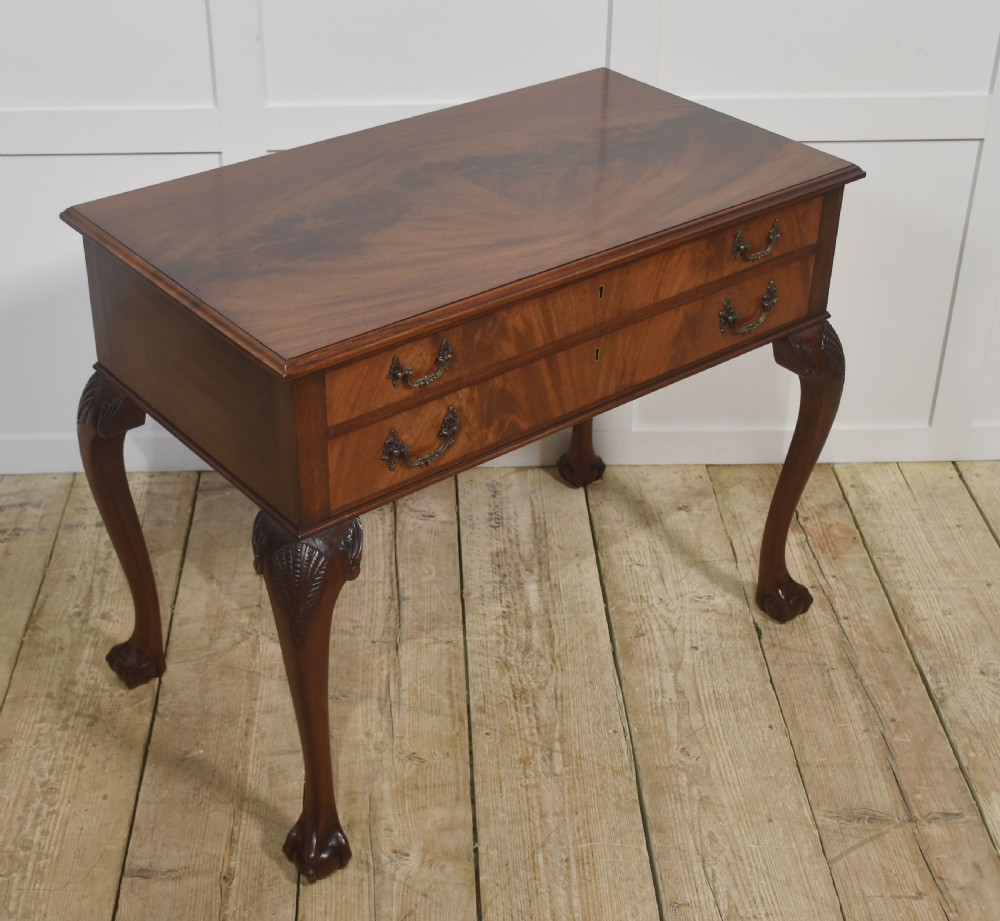 A polished mahogany cutlery chest table featuring two drawers with brass handles, raised on carved cabriole legs with ball and claw feet. View VII