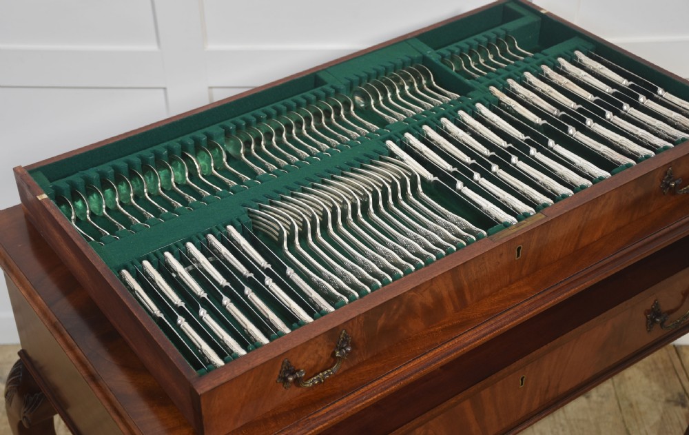 A polished mahogany cutlery chest table featuring two drawers with brass handles, raised on carved cabriole legs with ball and claw feet. View X