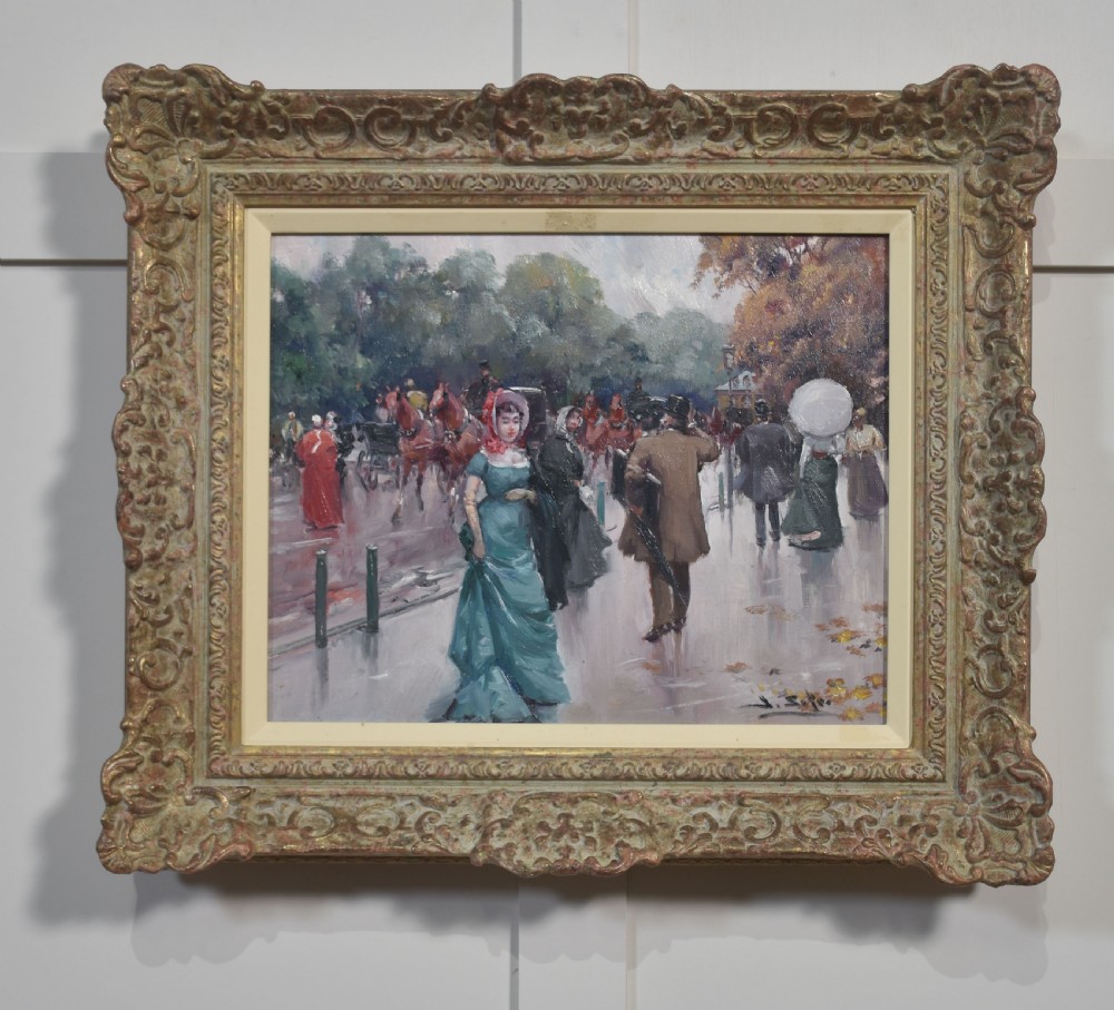 An oil painting depicting a street scene with figures in 19th-century clothing set within a carved gold gilt frame.
