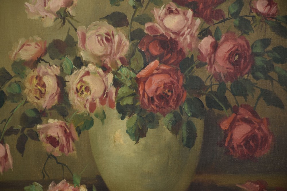 An antique framed oil painting depicting pink and red roses arranged in a light ceramic vase against a muted olive green background. View V