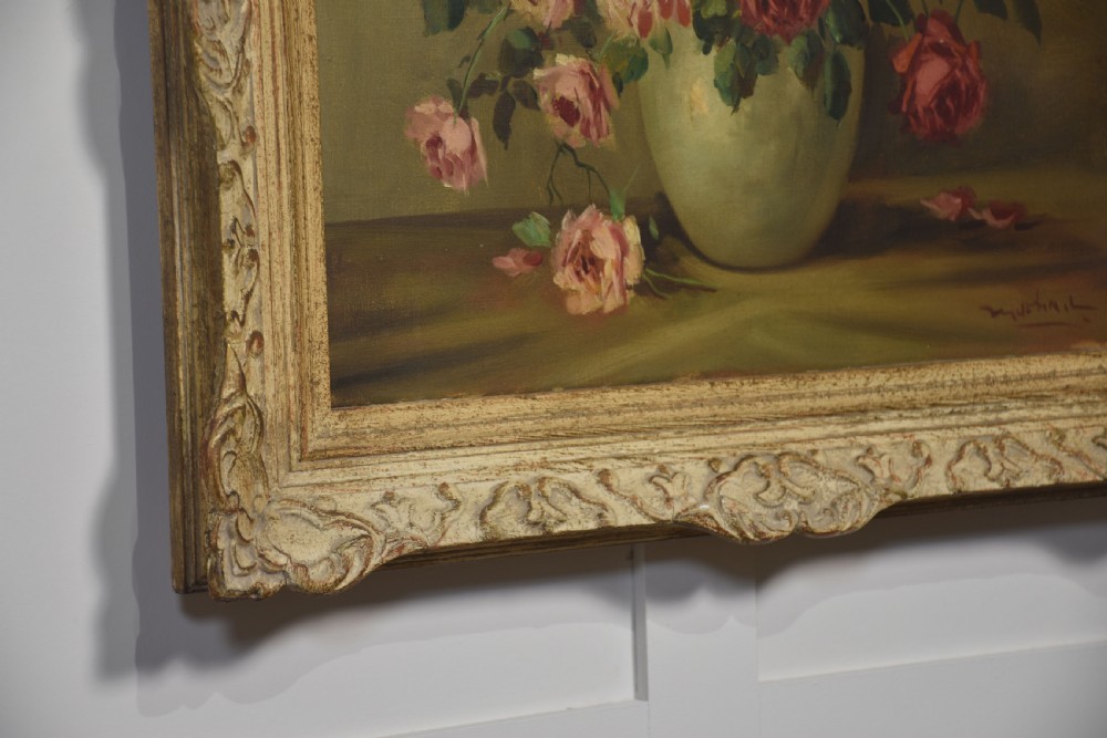 An antique framed oil painting depicting pink and red roses arranged in a light ceramic vase against a muted olive green background. View VII