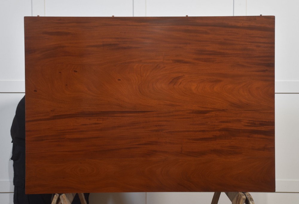 A long polished mahogany triple pedestal dining table featuring rounded corners, reeded splayed legs, and brass claw feet. View XVIII