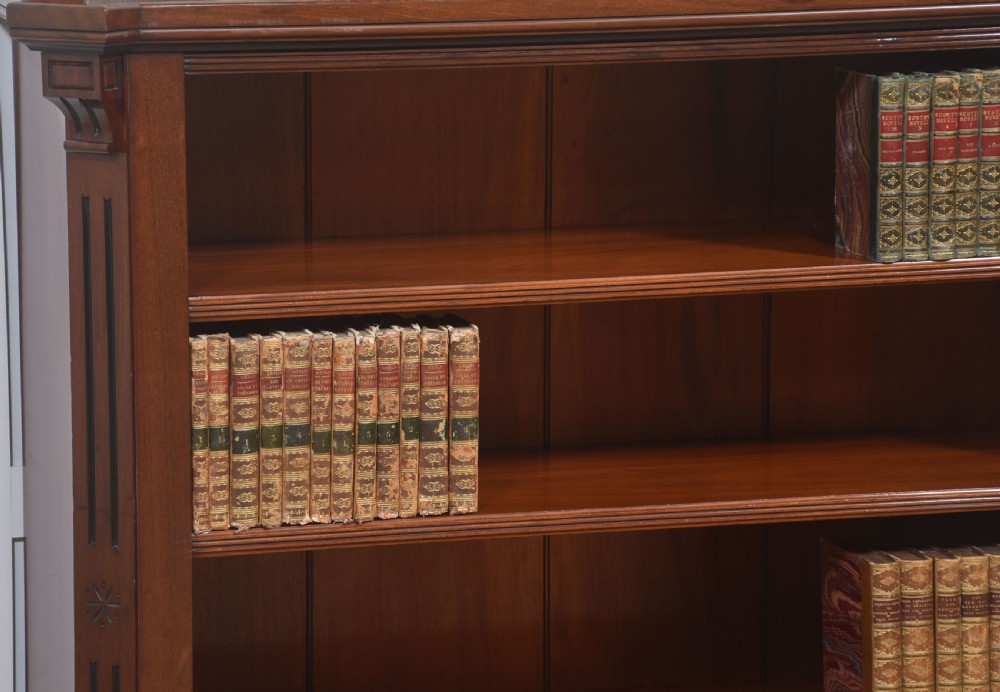 A Victorian mahogany open bookcase featuring four open shelves, fluted side columns, and a upper mirrored back with a turned spindle gallery. View III