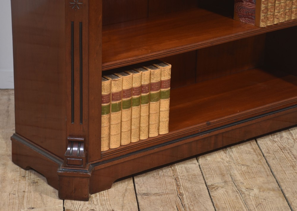 A Victorian mahogany open bookcase featuring four open shelves, fluted side columns, and a upper mirrored back with a turned spindle gallery. View VIII