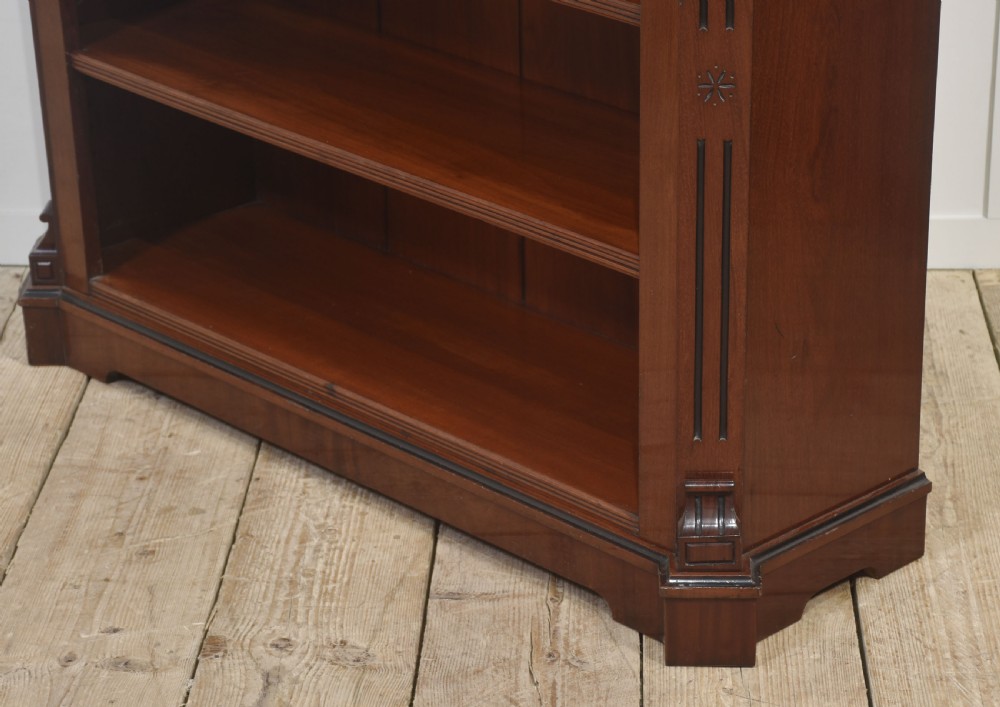 A Victorian mahogany open bookcase featuring four open shelves, fluted side columns, and a upper mirrored back with a turned spindle gallery. View XII