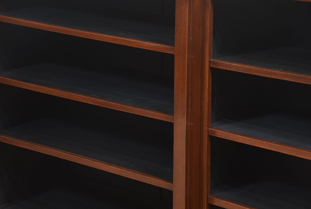 A wide mahogany open breakfront bookcase with four tiers of shelving containing antique leather-bound books. View XV