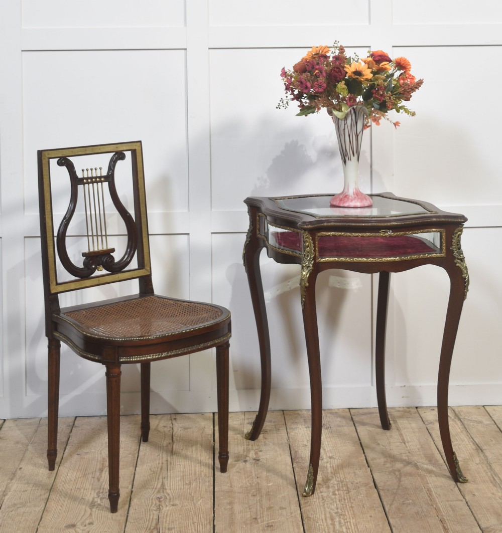 A mahogany bijouterie table featuring glass top and side panels, red velvet interior lining, brass mounts, and cabriole legs. View II