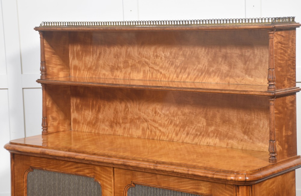 A William IV golden wood chiffonier featuring two open upper shelves with turned supports above a double-door cabinet with pleated fabric panels. View XIV