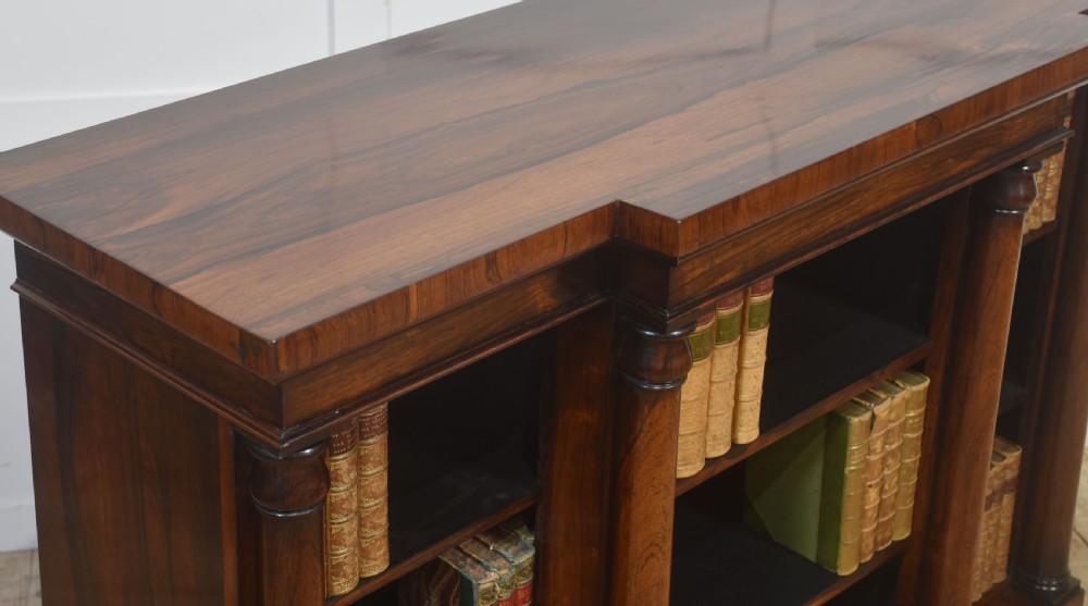 A nineteenth-century rosewood breakfront open bookcase with a projecting centre section flanked by turned column pilasters. View VII