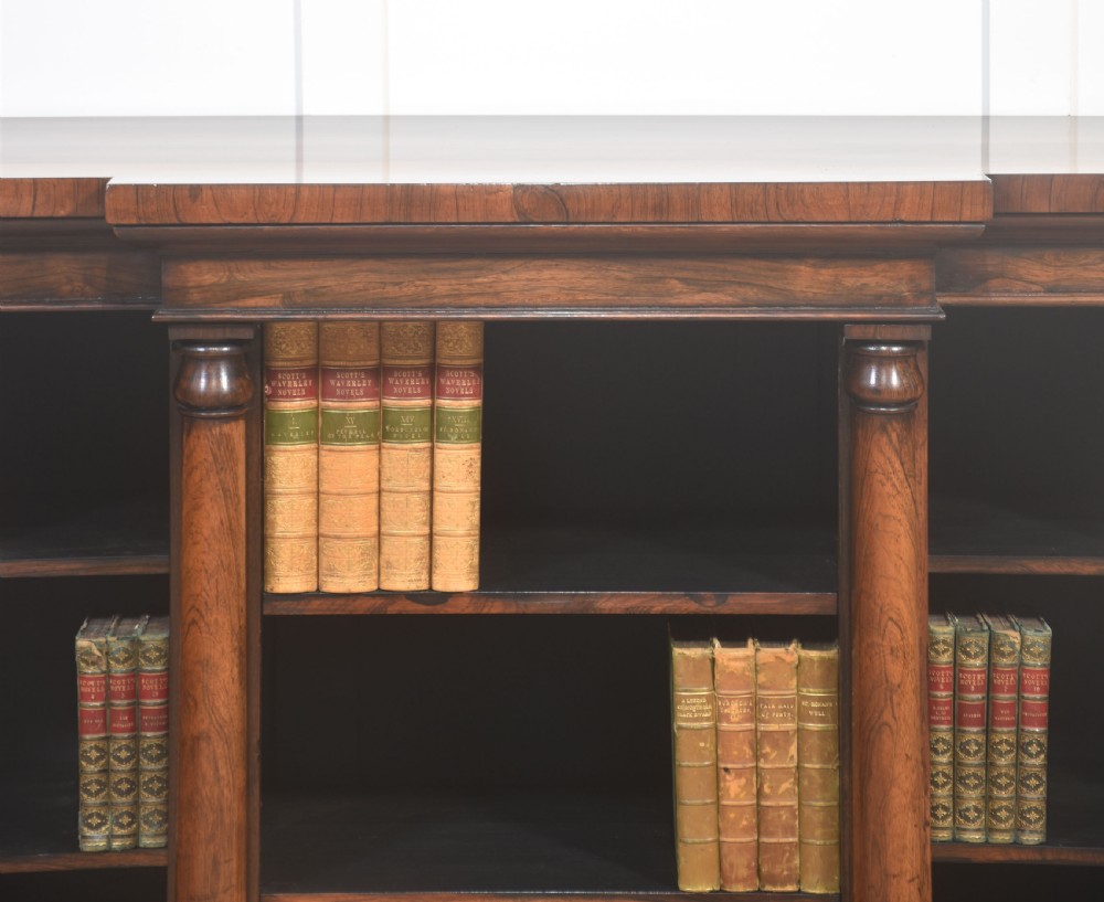 A nineteenth-century rosewood breakfront open bookcase with a projecting centre section flanked by turned column pilasters. View VIII