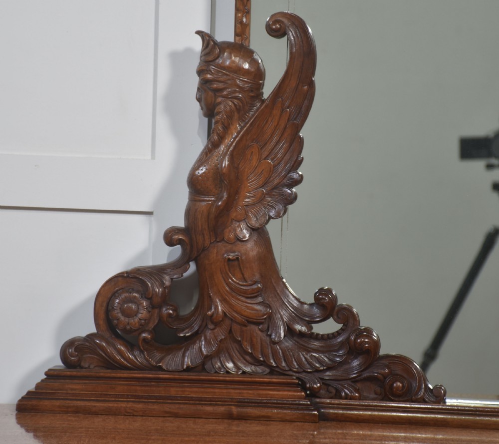 A 19th-century mahogany dressing chest featuring three flame mahogany drawers, carved sphinx supports framing a tall rectangular mirror, a marble top, and brass handles. View III