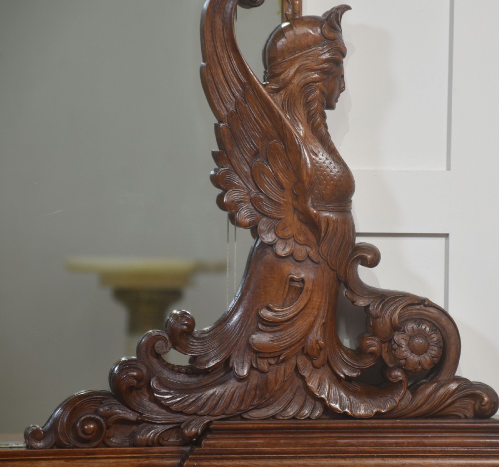 A 19th-century mahogany dressing chest featuring three flame mahogany drawers, carved sphinx supports framing a tall rectangular mirror, a marble top, and brass handles. View VII