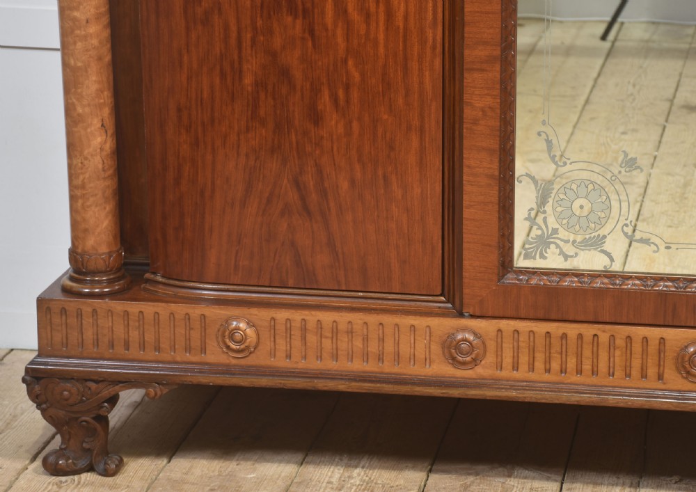 Large Victorian mahogany four-door wardrobe with central etched mirror doors, carved frieze, fluted side columns, and bracket feet. View III