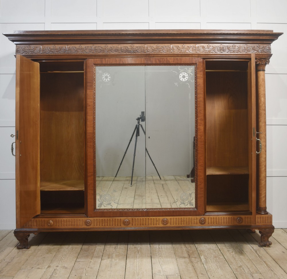 Large Victorian mahogany four-door wardrobe with central etched mirror doors, carved frieze, fluted side columns, and bracket feet. View VIII