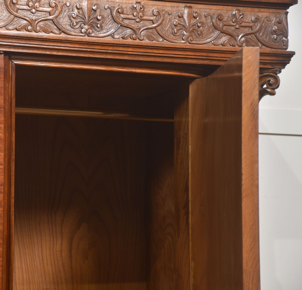 Large Victorian mahogany four-door wardrobe with central etched mirror doors, carved frieze, fluted side columns, and bracket feet. View IX