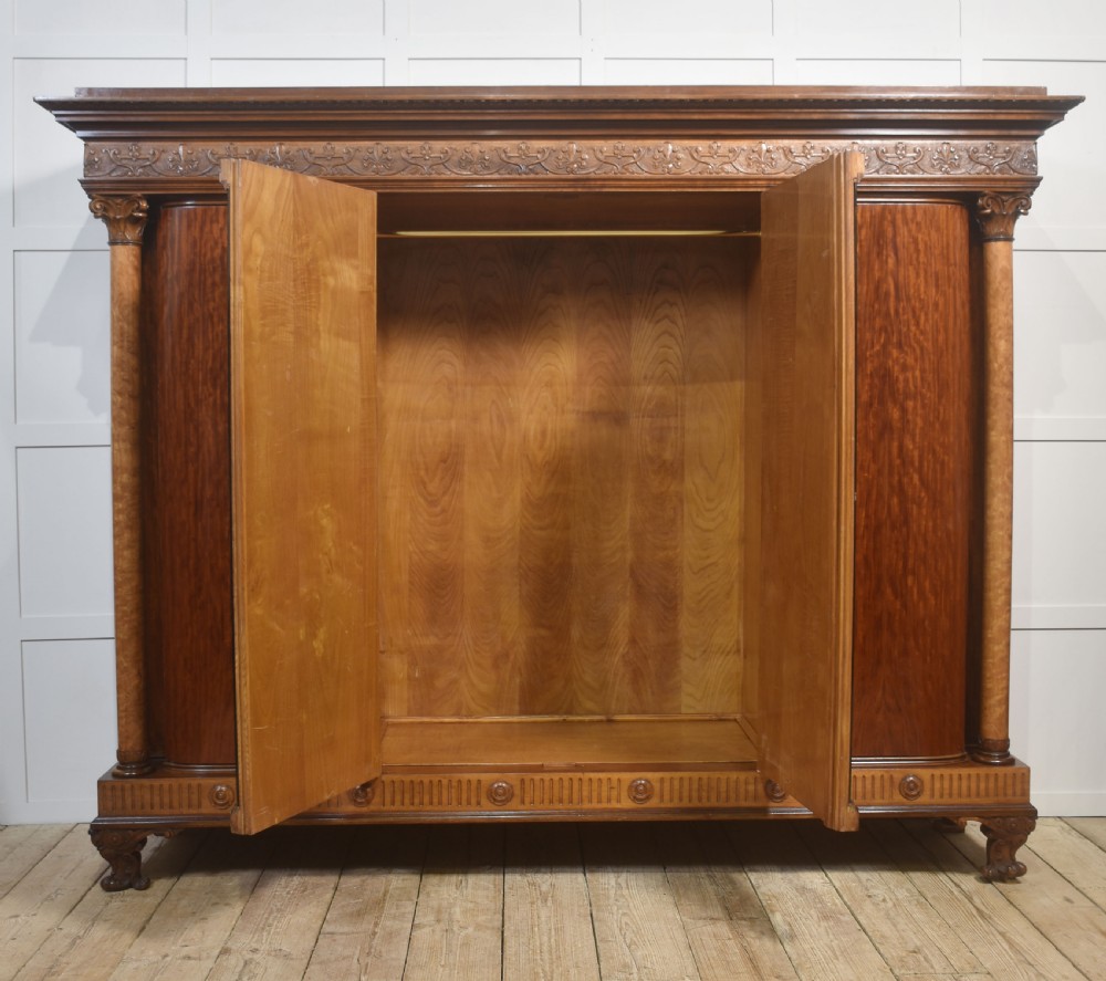 Large Victorian mahogany four-door wardrobe with central etched mirror doors, carved frieze, fluted side columns, and bracket feet. View XI