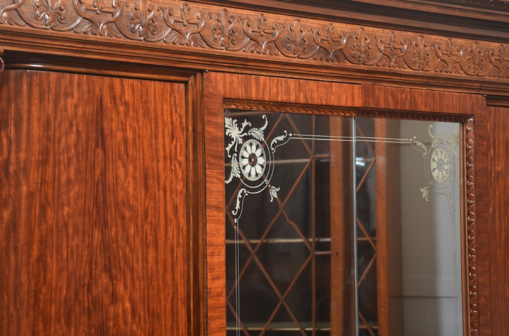 Large Victorian mahogany four-door wardrobe with central etched mirror doors, carved frieze, fluted side columns, and bracket feet. View XVIII
