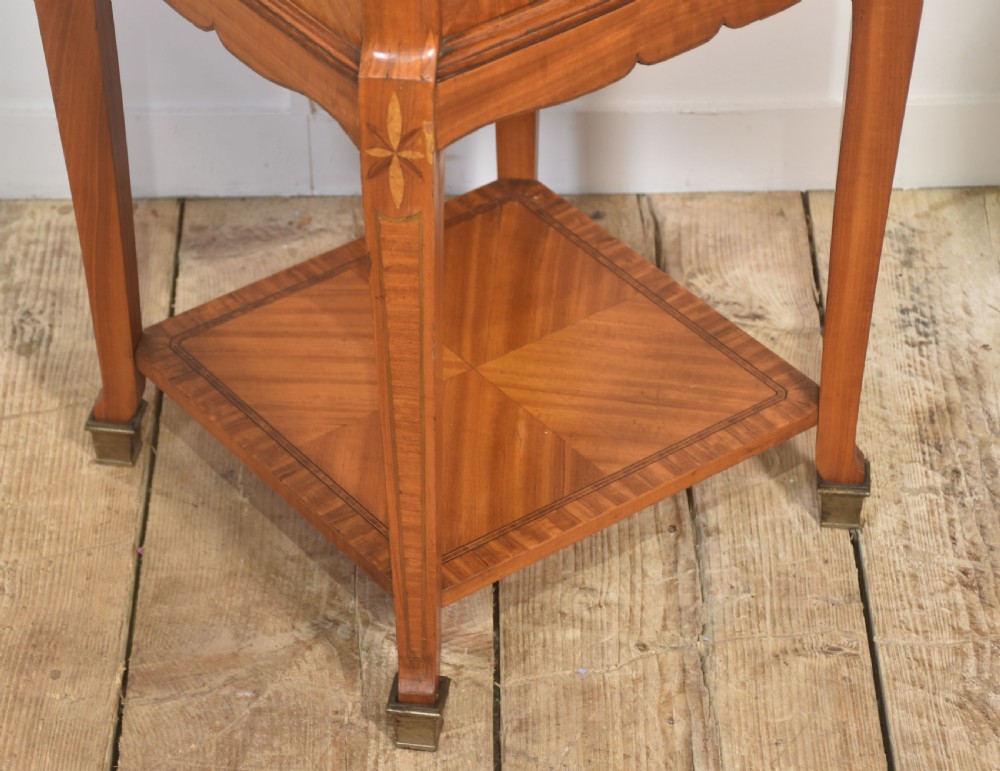 A pair of tall French satinwood bedside cabinets with marble tops, marquetry oval medallions, drawers, and slender legs. View XI