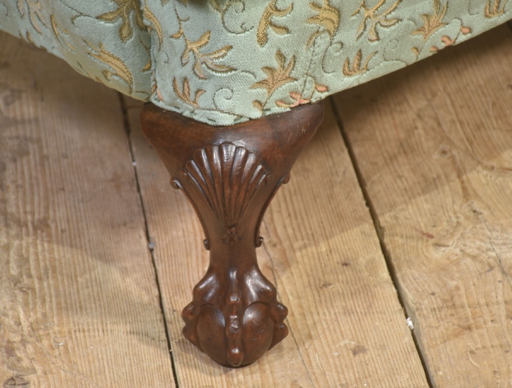 A Queen Anne style three-seat wingback sofa upholstered in patterned green fabric with carved cabriole legs and ball-and-claw feet. View III