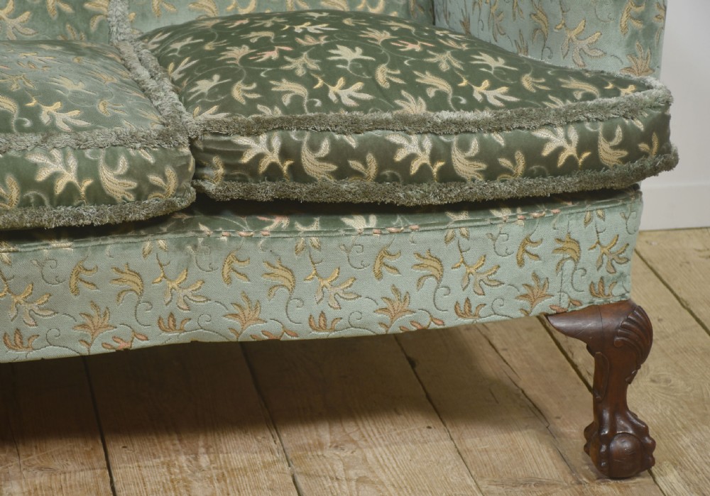 A Queen Anne style three-seat wingback sofa upholstered in patterned green fabric with carved cabriole legs and ball-and-claw feet. View VII