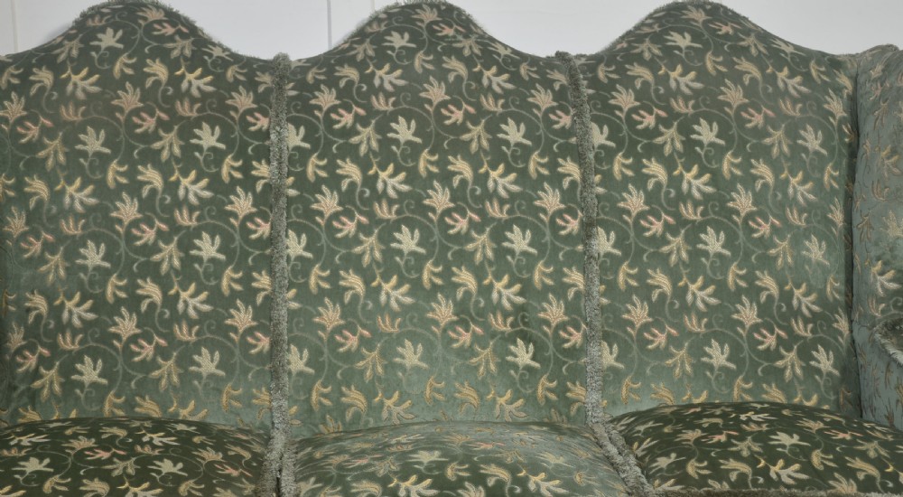 A Queen Anne style three-seat wingback sofa upholstered in patterned green fabric with carved cabriole legs and ball-and-claw feet. View VIII