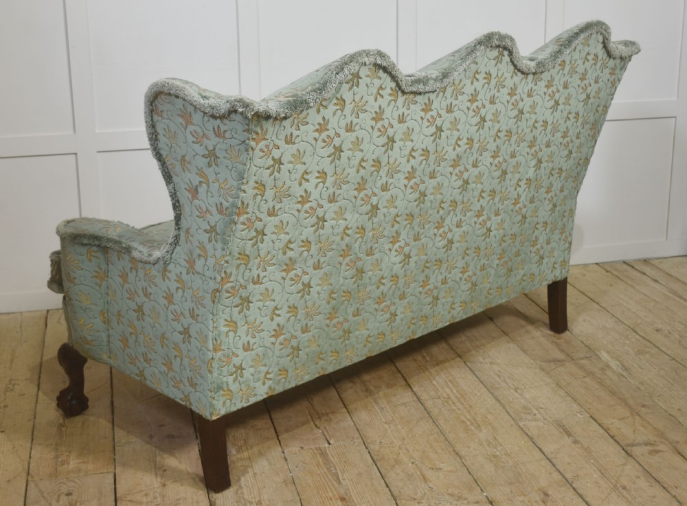 A Queen Anne style three-seat wingback sofa upholstered in patterned green fabric with carved cabriole legs and ball-and-claw feet. View XI