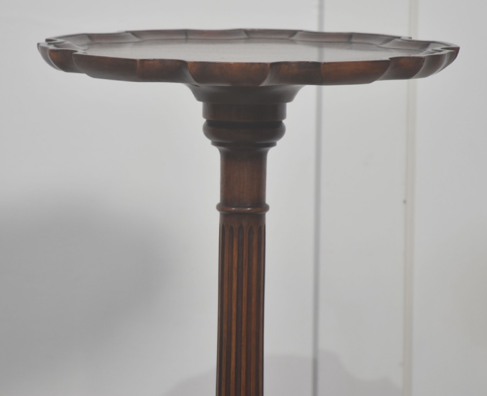 A tall mahogany tripod wine table featuring a scalloped piecrust rim, reeded column, and carved legs with ball and claw feet. View VI
